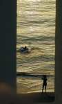 Kalamaki - the golden ocean at sunset, as seen thru the crenellations of our roof deck. (330x550, 109.4 kilobytes)