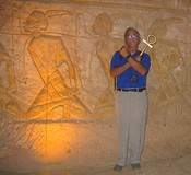 Max, holding an <em>Ankh,</em> poses as an Osirid statue.