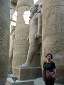 Two Rameses II stand among the pillars, while Gloria imitates the stance.