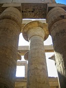 The capitals of the central columns in the Great Hypostyle Hall are bell-shaped open papyrus flowers,