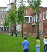 Kids & parents playing <em>Take a Giant Step</em> under the art