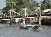 Steel Bridge with tourists, just off the Mekong