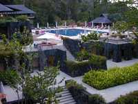 Our high room faced the rain forest on one side and the pool on the other.  Earlier in the day, in the sun, the umbrellas were unfurled and the chairs occupied. (1600x1200, 419.2 kilobytes)