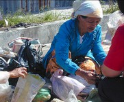 Another betel nut user.  What does she sell in the plastic bags? (603x500, 94.0 kilobytes)