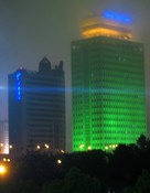 Tonight the garish lights of the Shanghai skyscrapers are softened by the fog.