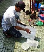 Cutting ice for the fish and meat vendors