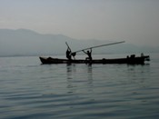 Digging vegetation and muck from the lake bottom