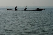 Hard at work digging vegetation and muck from the bottom of Inle lake