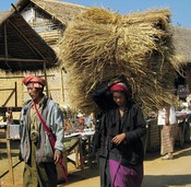 Carrying off straw from the Intain Market is, of course, woman's work.