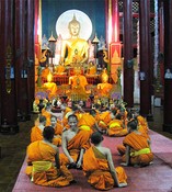 At Wat Pan Tao next door, young monks are gathered to wait for prayers to be led