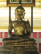 A Buddha disfigured by gold leaf