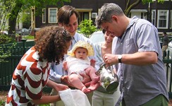 Godparents Maria and Jonathan wash Rosie's feet