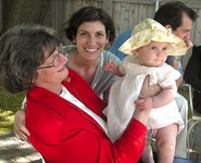 Susan holds Rosie, while Sarah smiles for the camera